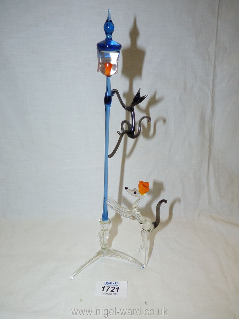 A coloured glass sculpture of dog chasing cat up lamppost. - Image 2 of 4