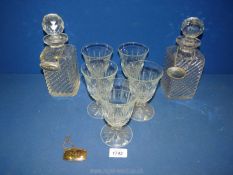 Two small decanters and stoppers, five wine glasses and three decanter labels for Brandy,