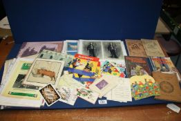 A box of assorted Arts and Crafts, Louis Wain pictures, sports photographs, advertising logos,