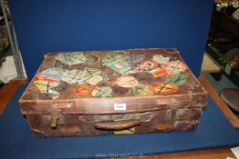 A leather suitcase with luggage labels.