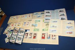 A small quantity of Wills Cigarette books and cards including railway engines, footballers etc.