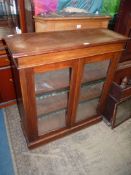 A circa 1900 Satinwood floor standing enclosed Bookcase with glazed doors and adjustable shelving,