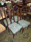 A set of four Mahogany framed Dining Chairs, on cabriole front legs,