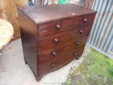 A Mahogany chest of three long and two short drawers with turned wood knobs and standing on turned