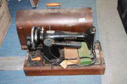 A Singer sewing machine in bentwood case