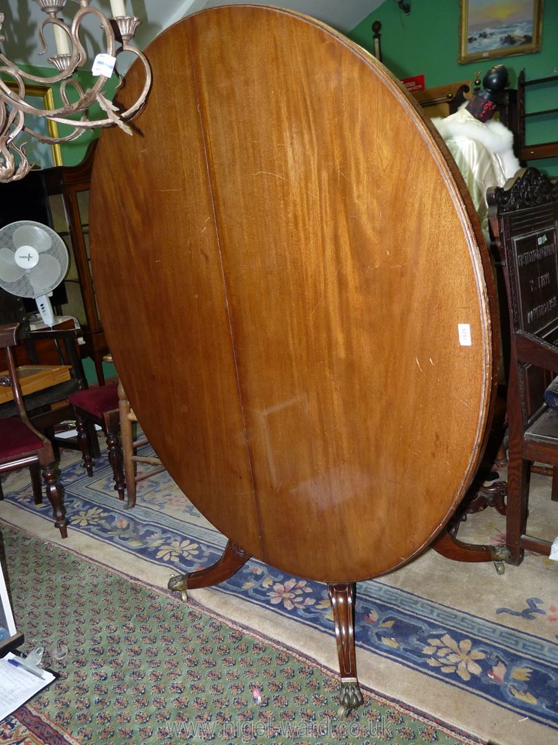 A Regency Mahogany snap-top Hall/Centre Table standing on a turned and lobed column on a platform