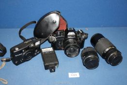 A Nikon EM 35 mm SLR Camera outfit including Nikon 35 mm f/2.5 , 100 mm f/2.8 and 75-150 mm f/3.
