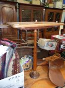 A Maple wood topped rectangular Occasional Table standing on a turned pillar and with shaped