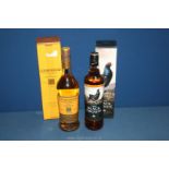 A bottle of Glenmorangie single malt whisky and a bottle of Famous Grouse whisky, both 70 cl.