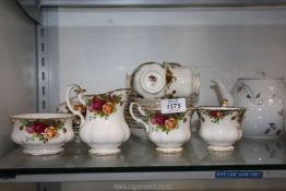 A Royal Albert 'Country Roses' part Teaset including six cups, nine saucers, milk jug, etc.