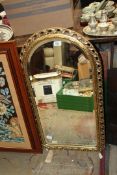 A gilt Mirror with oval top, approx. 18 1/2" x 33 1/2".