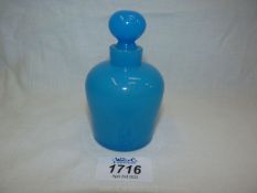 A mid-19th century opaque blue glass scent bottle with stopper.
