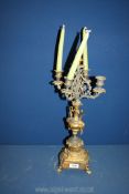 A four branch gilt metal and onyx candelabra standing on four paw feet, 22'' tall, a/f.