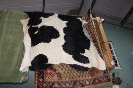 A large Friesian cow hide, 108" long x 70" wide approximately.