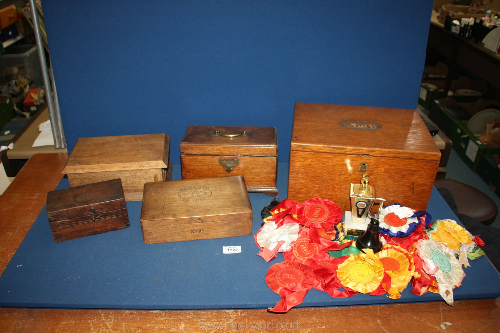 A quantity of wooden boxes and contents including rosettes for The Bird Society, cigar box,