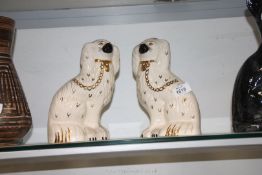 A pair of Royal Doulton white mantle Spaniels with gold chains.