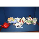 A quantity of novelty teapots including Leonardo Collection House with cat,