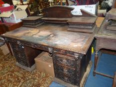 A continental design carved Oak double pedestal Desk with a frieze drawer over the kneehole,