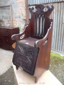 A most unusual Mahogany Arts & Crafts Purdonium/Child's Chair having a fret-worked and carved