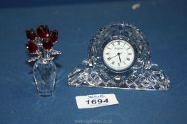 A boxed Waterford quartz miniature mantle clock and a boxed Swarovski crystal rose bouquet.