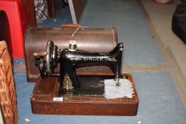 A Singer sewing machine in bentwood case, serial no. F8328274, with manual, case a/f.