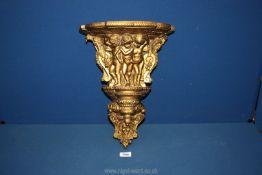 A decorative gilt and composition cherub wall sconce (20th century),