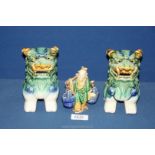 A pair of ceramic shaded green Temple Dogs, 6" tall, plus a water carrier figure a/f.