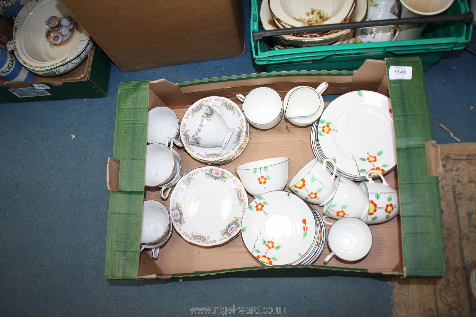 A quantity of part teasets including orange and yellow floral with black rim and oriental in pink