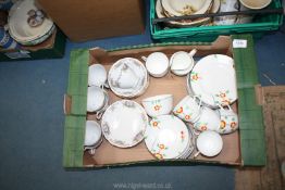 A quantity of part teasets including orange and yellow floral with black rim and oriental in pink