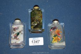 Three Chinese glass snuff bottles internally painted with dragons, figures and fish, each 8.