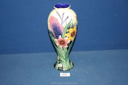An Old Tupton Ware vase with pink,purple and yellow flowers on navy and pale yellow ground,