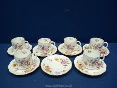 Six Royal Crown Derby coffee cups and seven saucers in ''Derby Posies'' pattern.