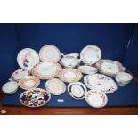 A quantity of various plates and saucers including gilt, blue and orange,