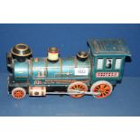 A Japanese made tin clockwork 'Western' train, no key, 12'' long, play worn.