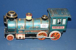 A Japanese made tin clockwork 'Western' train, no key, 12'' long, play worn.