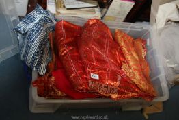 A quantity of red and orange textiles including satin damask brocade,