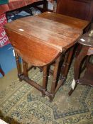 An Oak gateleg dropleaf Table on tapering turned legs,