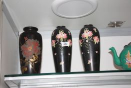 Three black ground Vases including a pair of Crown Devon with pink flower decoration,