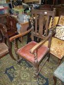 A 1930/40's Oak framed open armed Chair having mirrored twist legs and supports and red upholstered