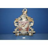 A metal wall Sconce having a coat of arms and Bohun swan style motif, 16 1/2" x 12".