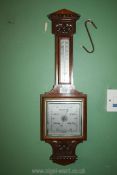 An oak cased barometer/thermometer