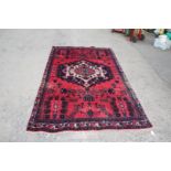 A Persian Hamadan Village rug, pinky/red ground, Medallion design, 2.4m x 1.48m.