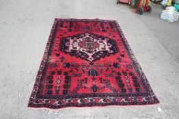 A Persian Hamadan Village rug, pinky/red ground, Medallion design, 2.4m x 1.48m.