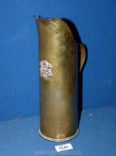 A brass shell case with the Prince of Wales feathers and motto, 11 1/4'' tall.