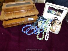 A white jewellery box and contents of beaded necklaces and rings plus a wooden jewellery box.