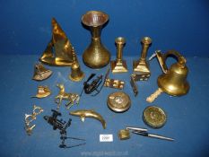 A quantity of brass including candlesticks, bell, dolphin, wall plaques, little ships clock,