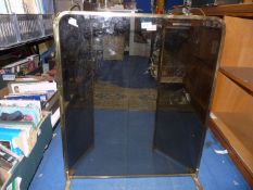 A Brass framed Fire screen with glass panels.