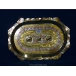 An Indian solid polished brass tray decorated in white metal and copper with floral design and