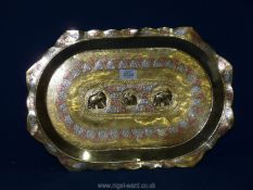 An Indian solid polished brass tray decorated in white metal and copper with floral design and