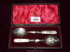 A presentation cased pair of high quality mother of pearl handled Spoons, the handles engraved 'M.D.